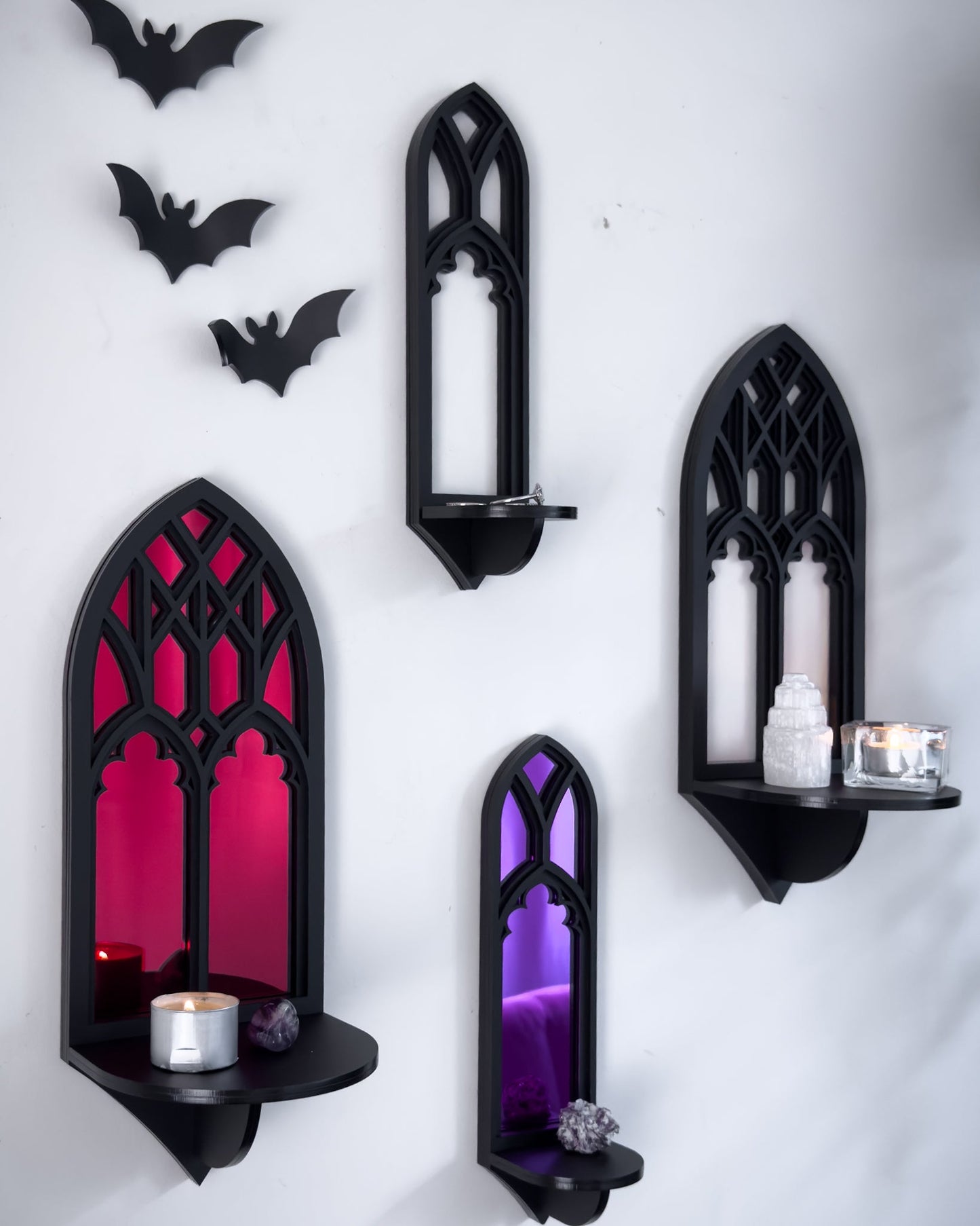 Close-up gallery wall featuring Salem gothic tracery wall shelves with acrylic bats on a white wall