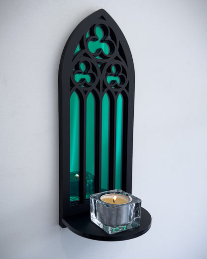 Side view of gothic cathedral wall shelf in black layered acrylic with green acrylic mirror inset and candle display