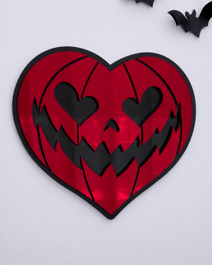 Red heart-shaped pumpkin mirror wall art in layered black acrylic on a bright cool-toned wall.