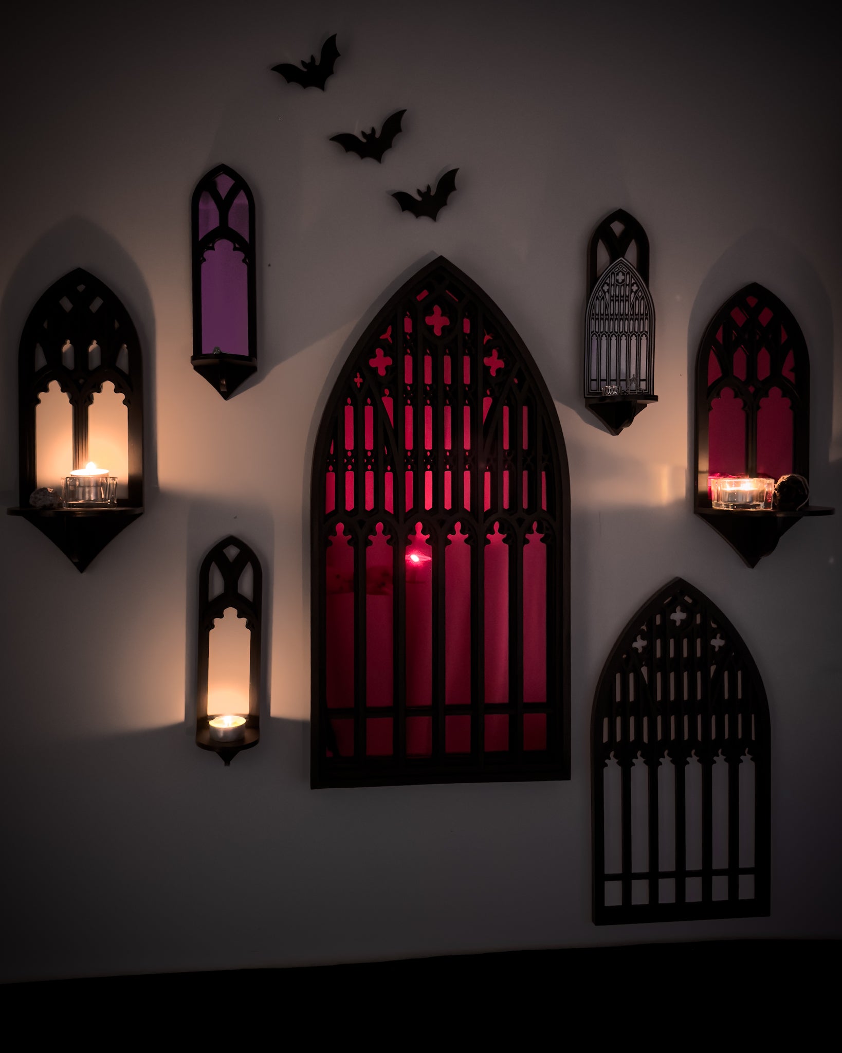 Salem Witch Museum gallery wall in candlelight featuring gothic cathedral mirrors and shelves