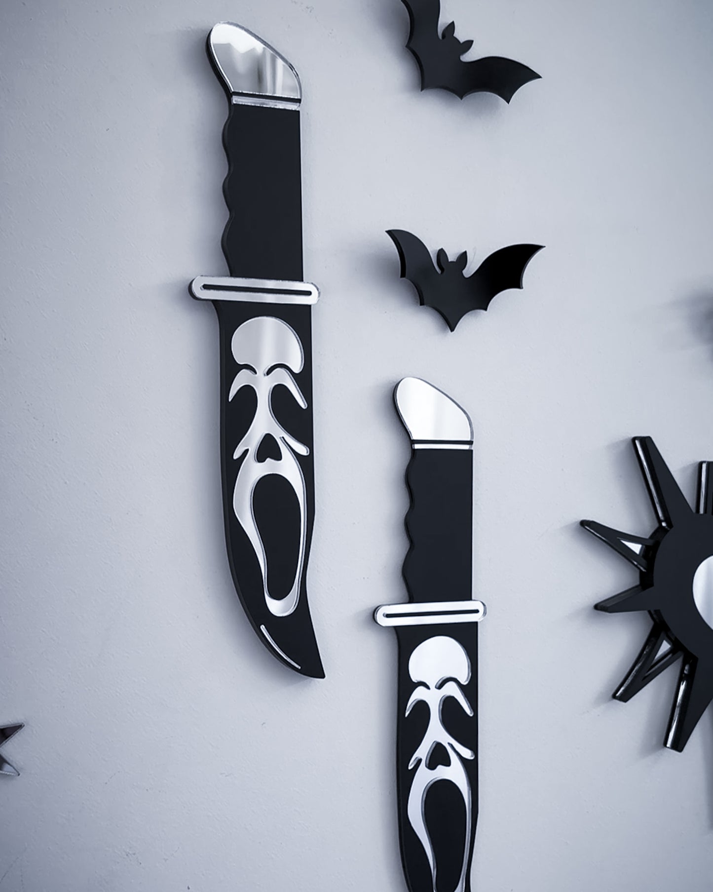Ghostface knife mirror wall art styled with black acrylic bats on wall