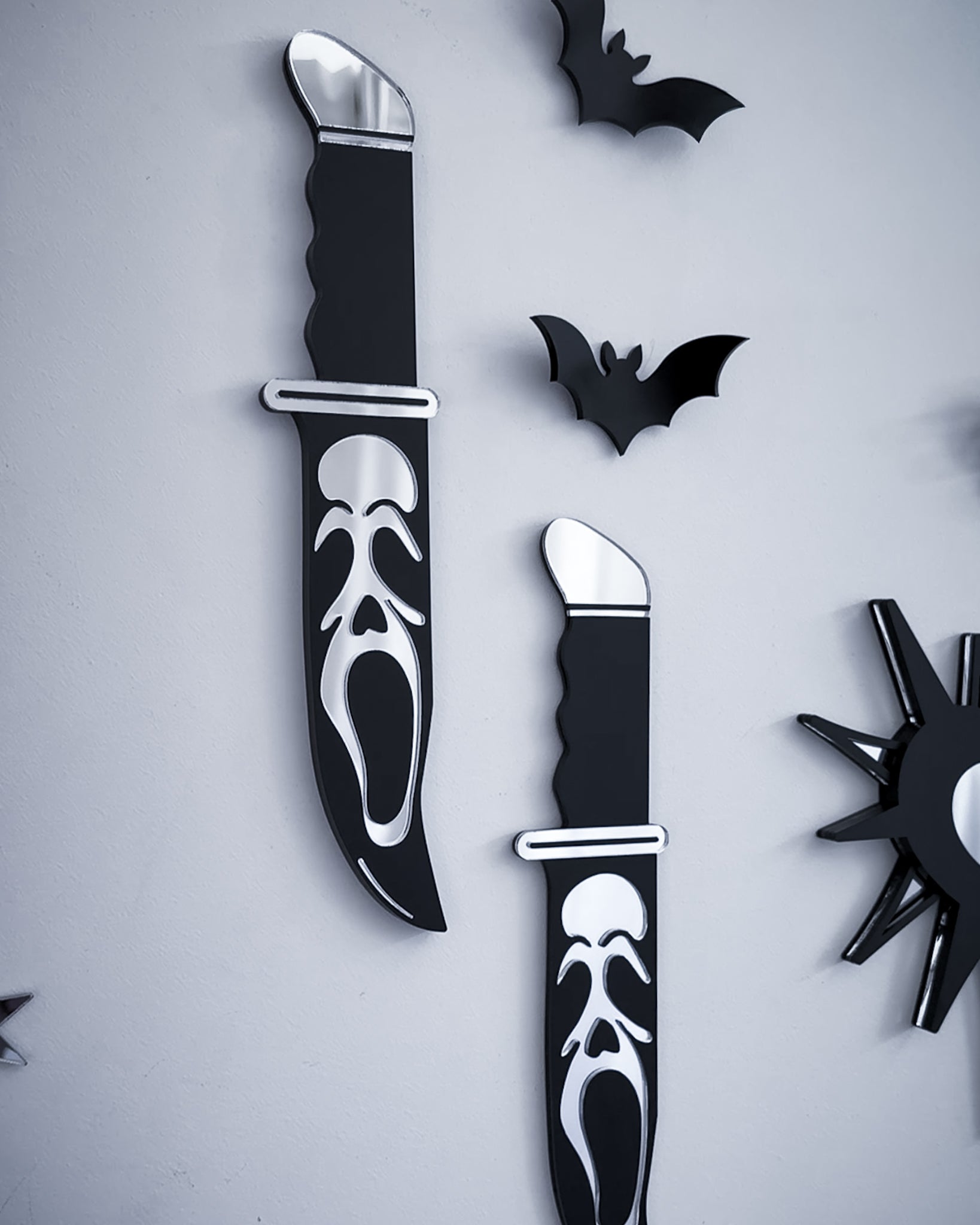 Ghostface knife mirror wall art styled with black acrylic bats on wall