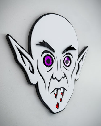 Side view of Nosferatu vampire face wall art in black and white acrylic with mirror purple eyes and blood detail