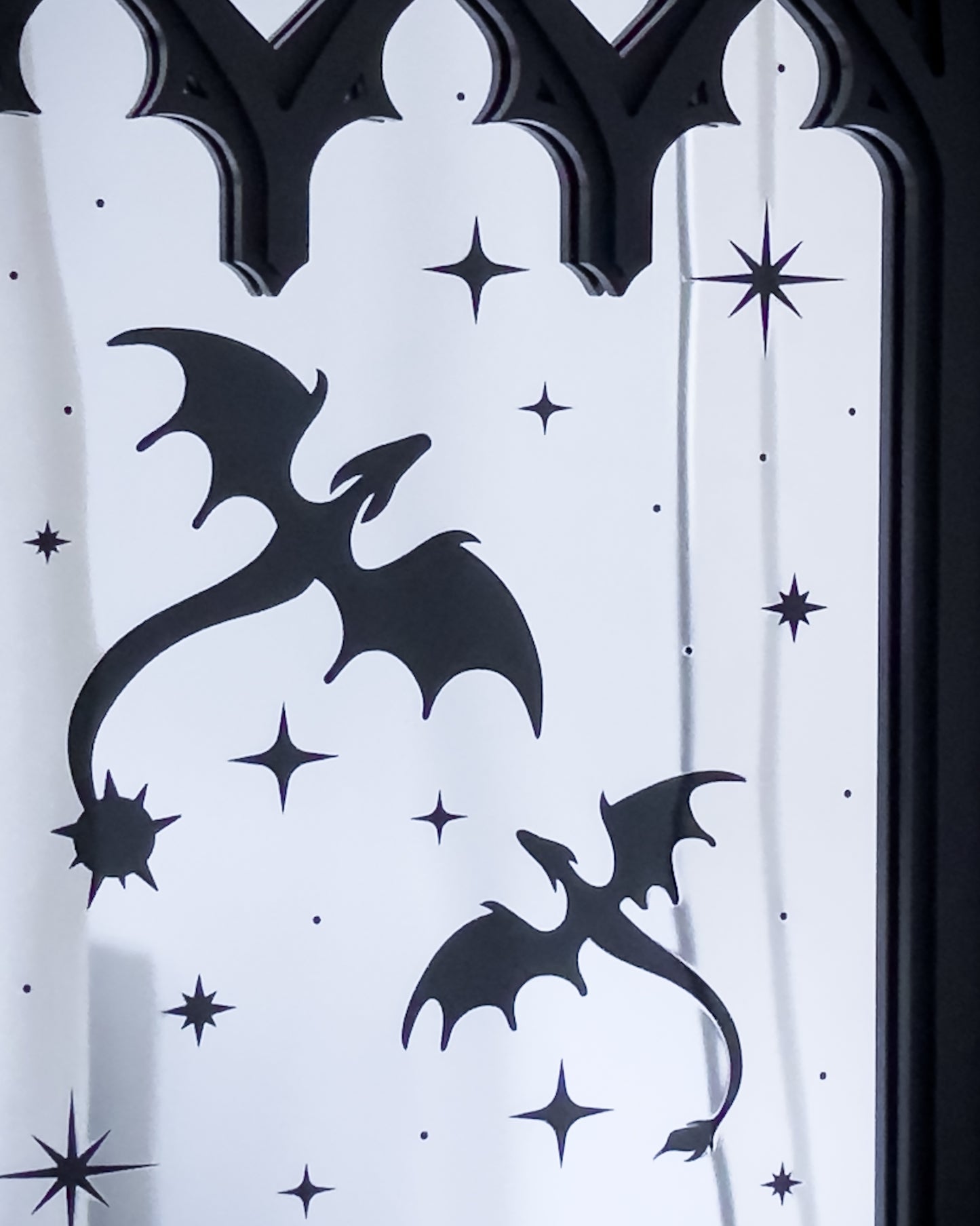Close up of gothic cathedral mirror with dragon silhouettes and star details