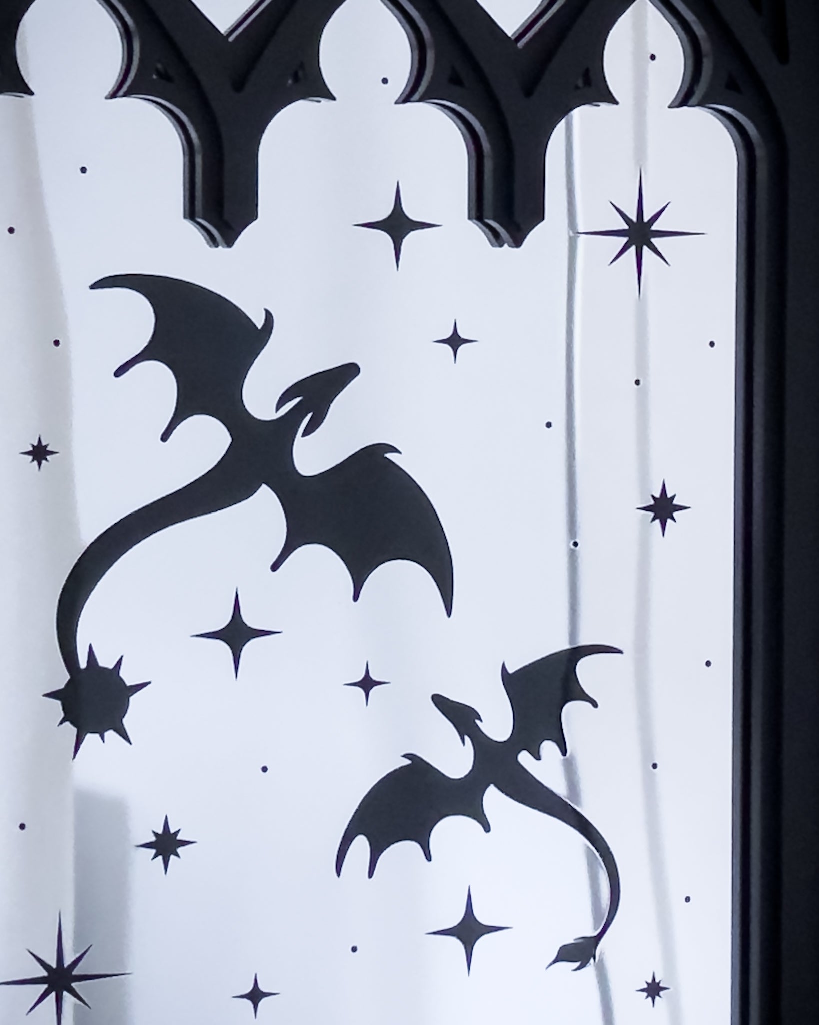 Close up of gothic cathedral mirror with dragon silhouettes and star details