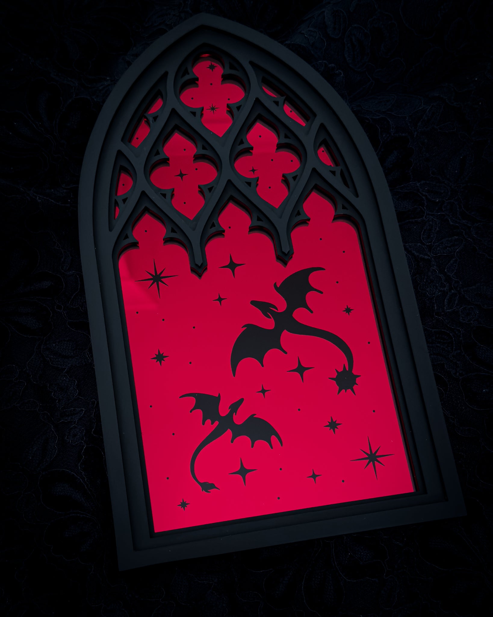 Gothic cathedral window mirror in red acrylic with dragon silhouettes on dark background