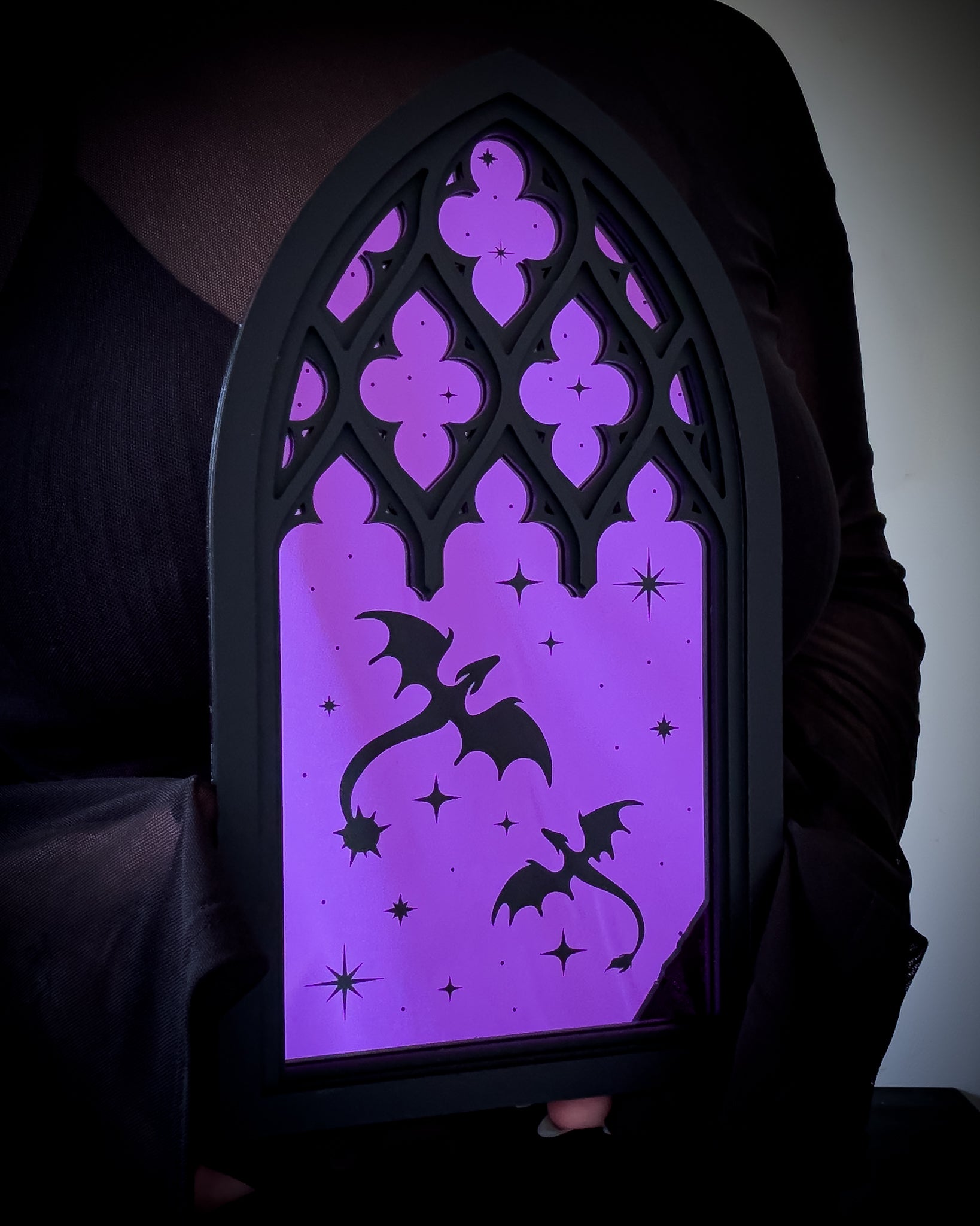 Gothic cathedral dragon window mirror with purple acrylic held for scale reference