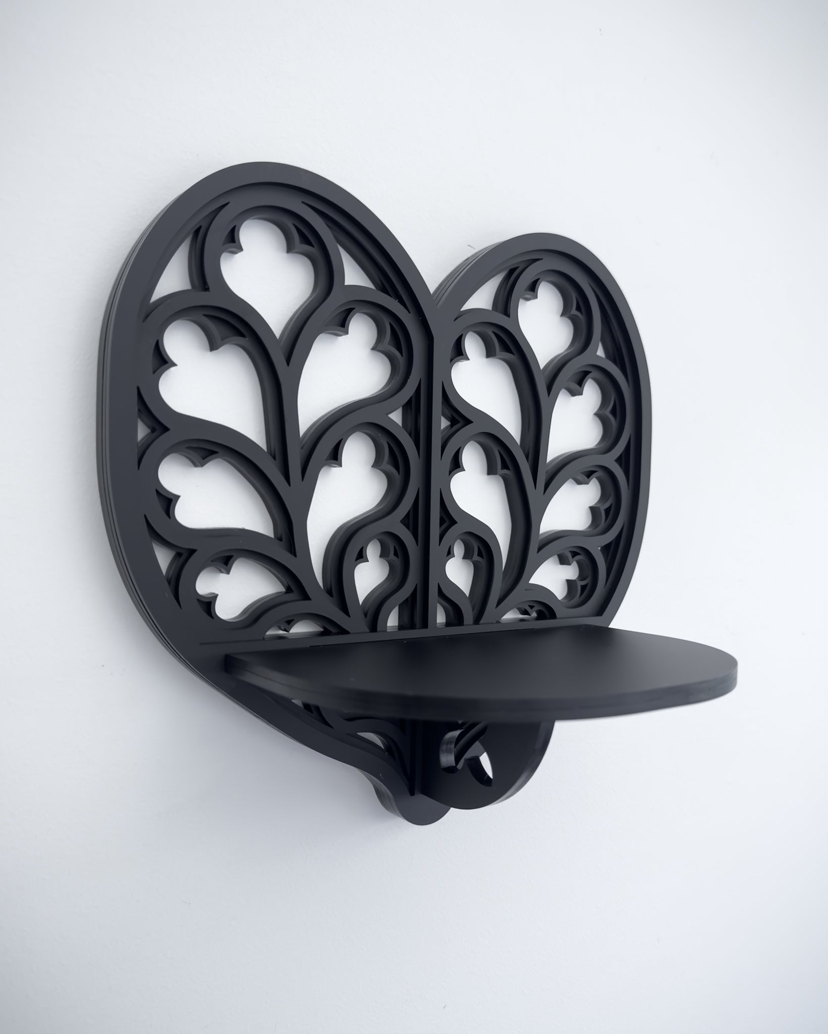 Close-up of Heart of Yorkshire cathedral tracery wall shelf in black layered acrylic
