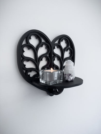 Side view of Heart of Yorkshire cathedral tracery wall shelf in black layered acrylic
holding candles and crystals 