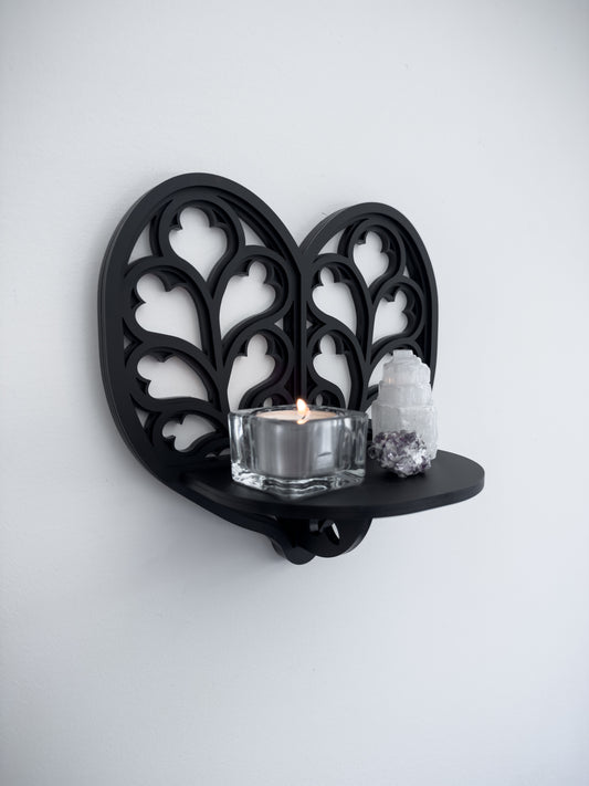 Side view of Heart of Yorkshire cathedral tracery wall shelf in black layered acrylic
holding candles and crystals 
