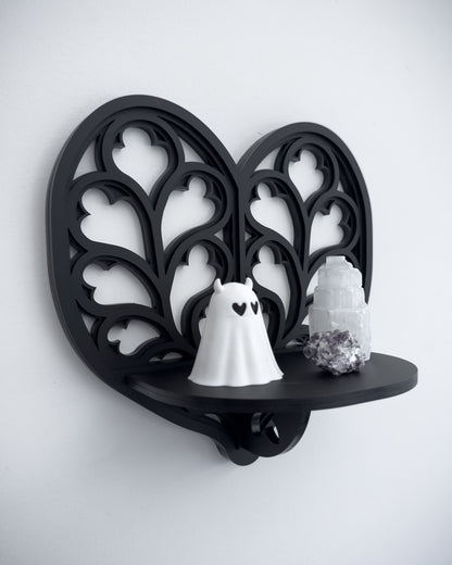 Close-up of Heart of Yorkshire cathedral tracery wall shelf in black layered acrylic holding crystals and trinkets