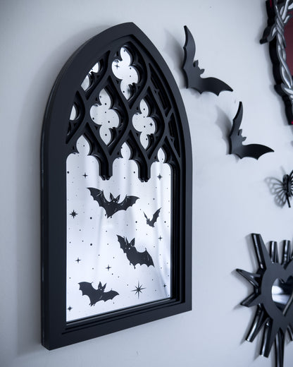 Gothic gallery wall featuring cathedral mirror wall art with bats, black acrylic decor, and flying bat wall accents