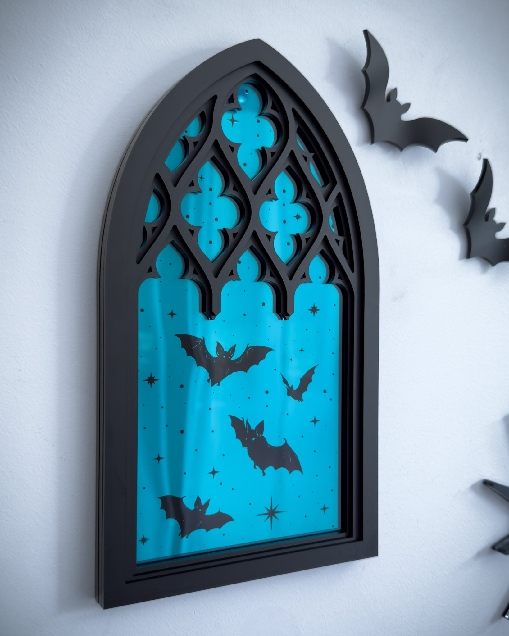 Gothic cathedral window wall art with teal mirror acrylic centre and black silhouette bats