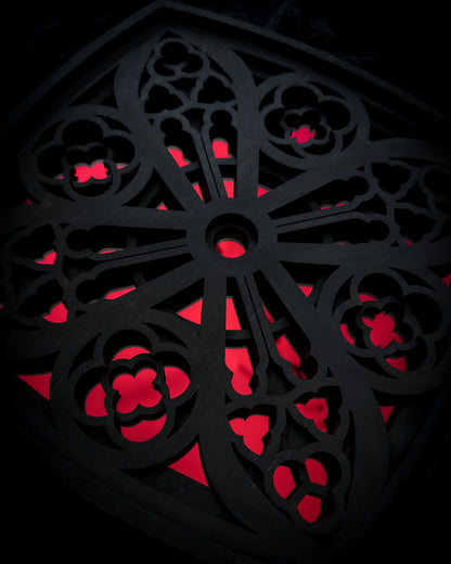 Close-up detail of Cologne Cathedral window in black layered wood with red acrylic mirror centre