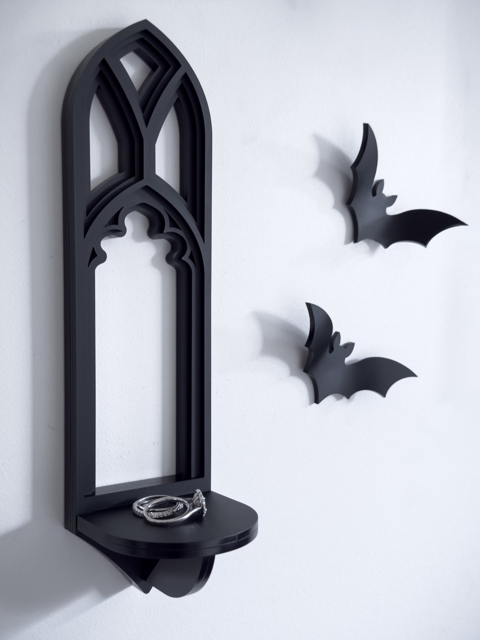 Salem tracery wall shelf in black layered acrylic on a white gallery wall with acrylic bats