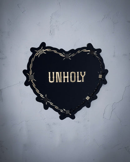 Unholy gothic heart wall art with barbed wire design in gold and black acrylic on textured grey wall
