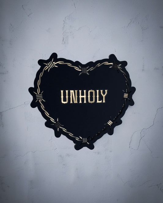 Unholy gothic heart wall art with barbed wire design in gold and black acrylic on textured grey wall