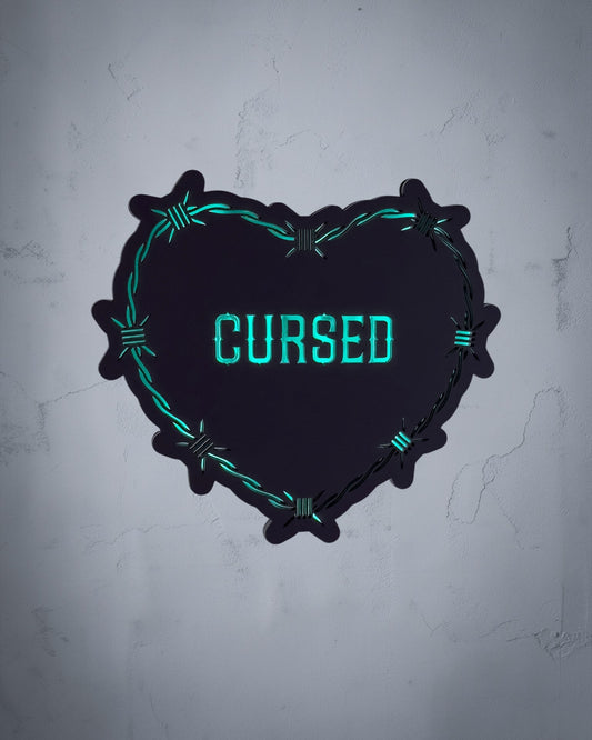 Cursed gothic heart wall art with barbed wire design in green and black acrylic on textured grey wall