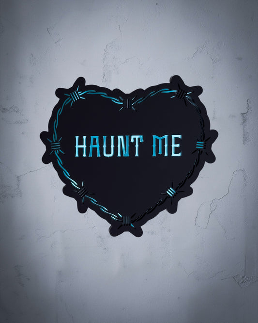 Haunt Me gothic heart wall art with barbed wire design in teal and black acrylic on textured grey wall