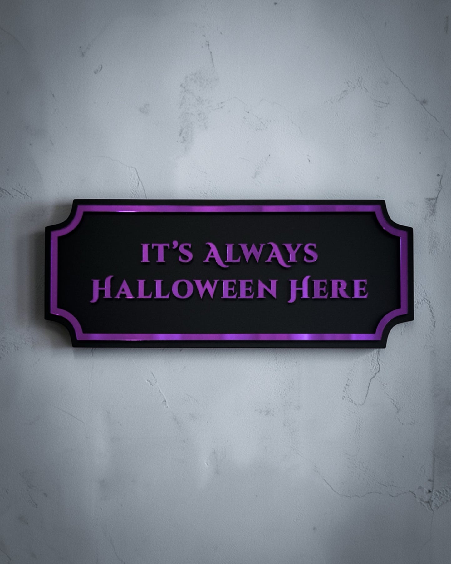 It’s always Halloween here gothic wall art plaque in purple mirror on textured grey wall