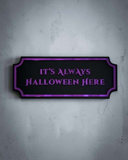 It’s always Halloween here gothic wall art plaque in purple mirror on textured grey wall