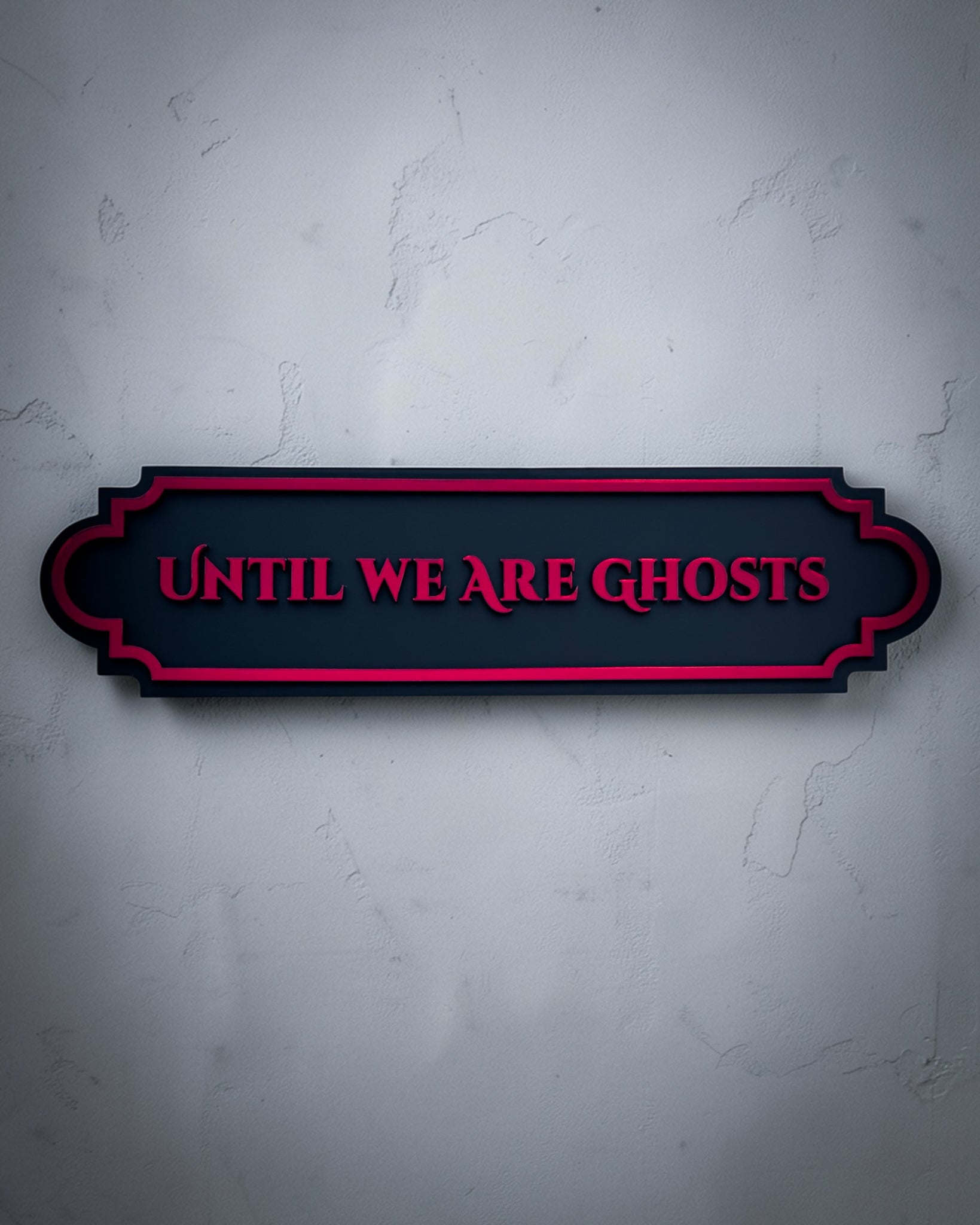 Until we are ghosts gothic wall art plaque in red mirror on textured grey wall