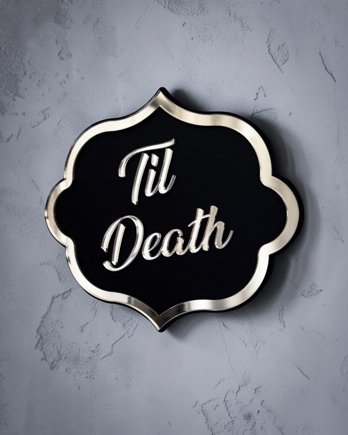 Side view of Til death gothic wall art plaque in gold mirror on textured grey wall