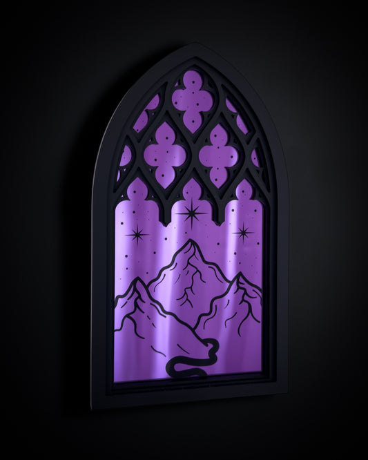 Gothic cathedral mirror wall art with purple acrylic window and engraved mountain and stars design on dark background