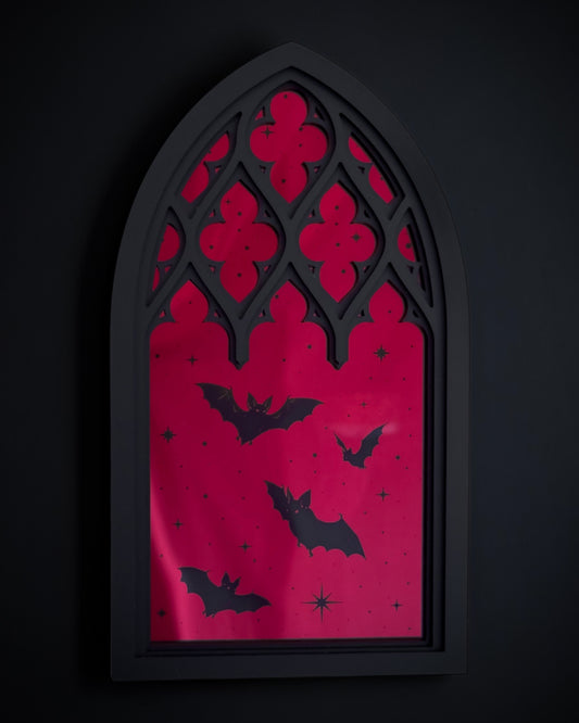Gothic cathedral window wall art with red acrylic mirror and  black bats flying across the design
