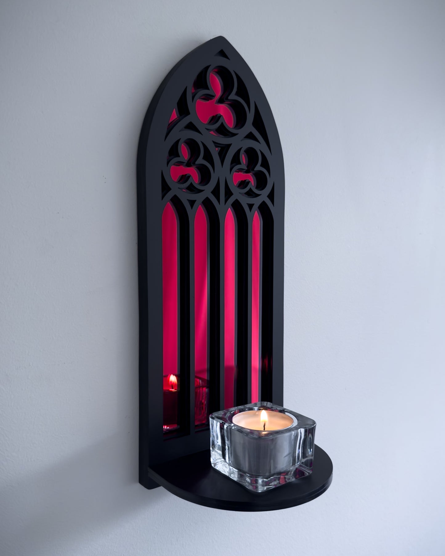 Side view of gothic cathedral wall shelf in black layered acrylic with red acrylic mirror inset and candle display