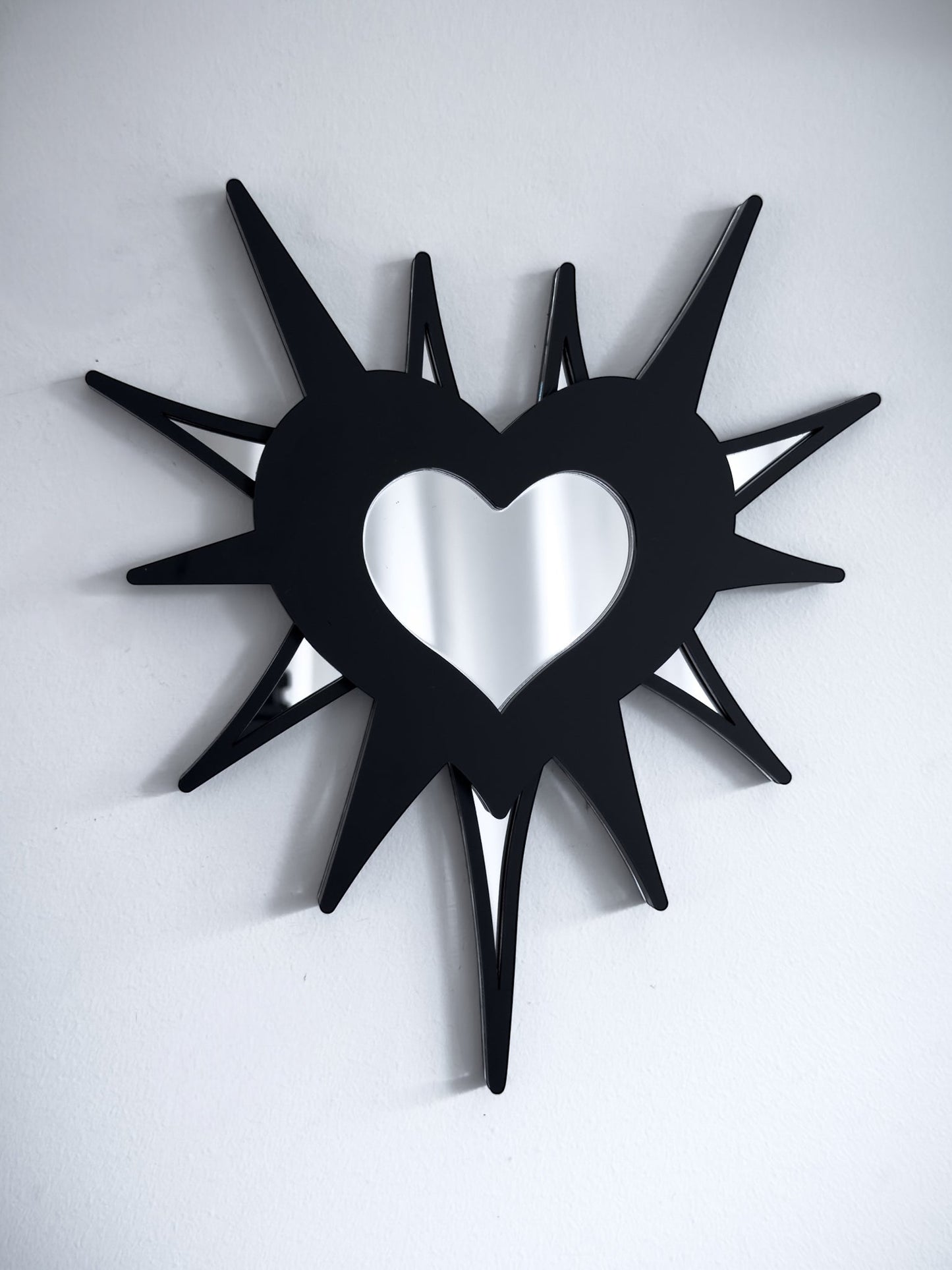 Gothic spiked barb heart mirror in black acrylic with silver mirrored centre, wall mounted