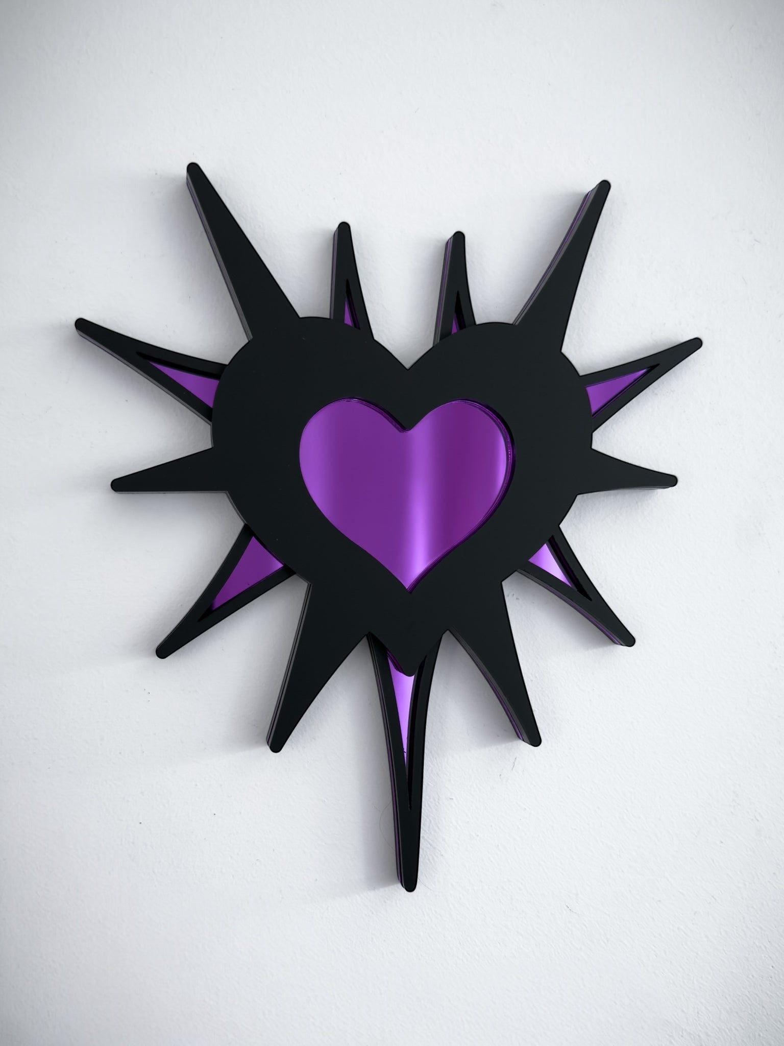 Gothic spiked barb heart mirror in black acrylic with purple mirrored centre, wall mounted