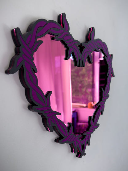 Side view of purple and pink barbed wire heart mirror in layered acrylic gothic wall decor