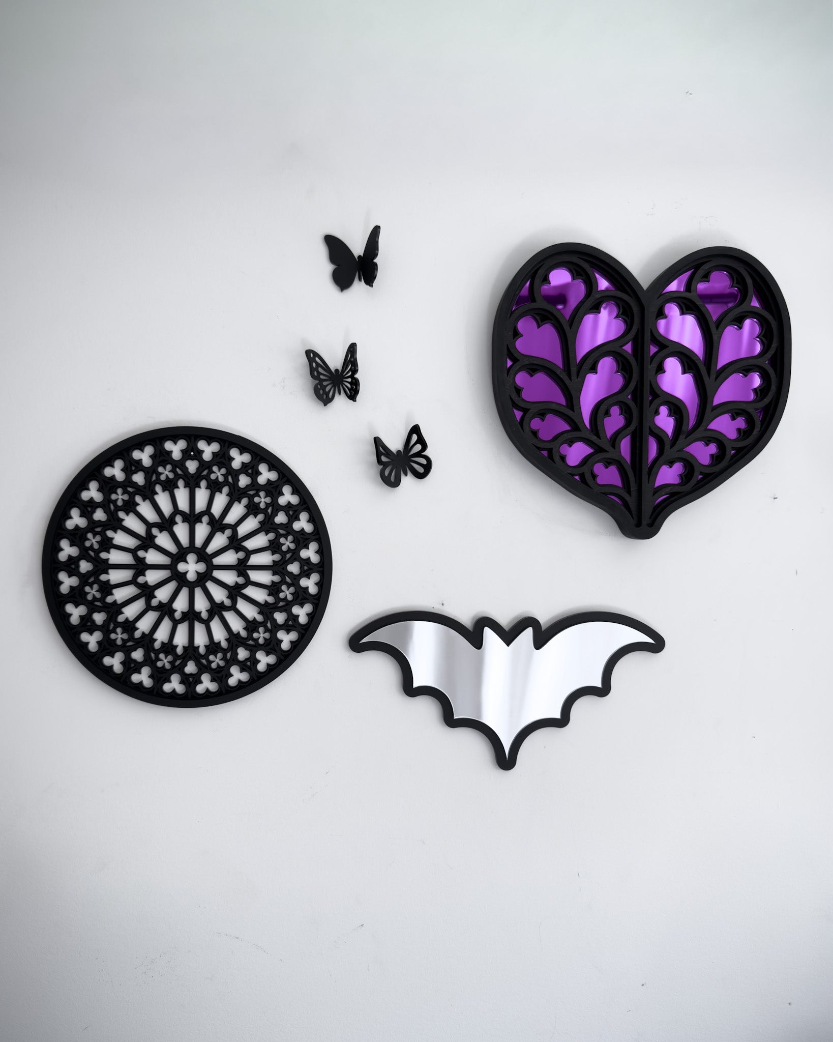 Bat mirror wall art styled in a gothic gallery wall with tracery Notre Dame rose window and purple mirror Heart of Yorkshire decor