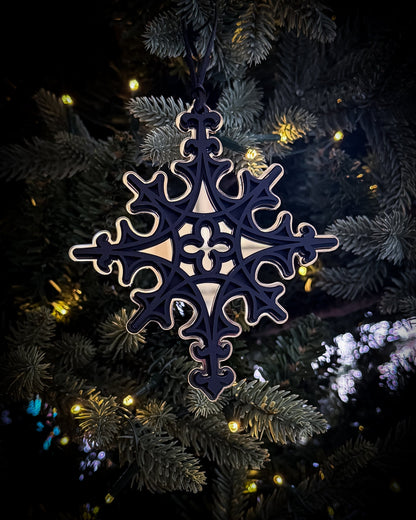 Gold Gothic cathedral star ornament hanging on Christmas tree with warm lights