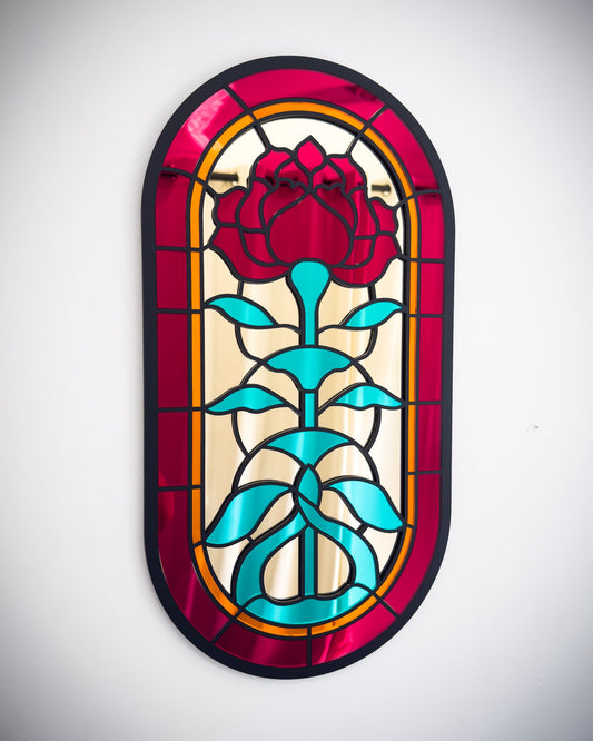 Gothic stained glass rose window mirror with red, gold and green acrylic on a white wall