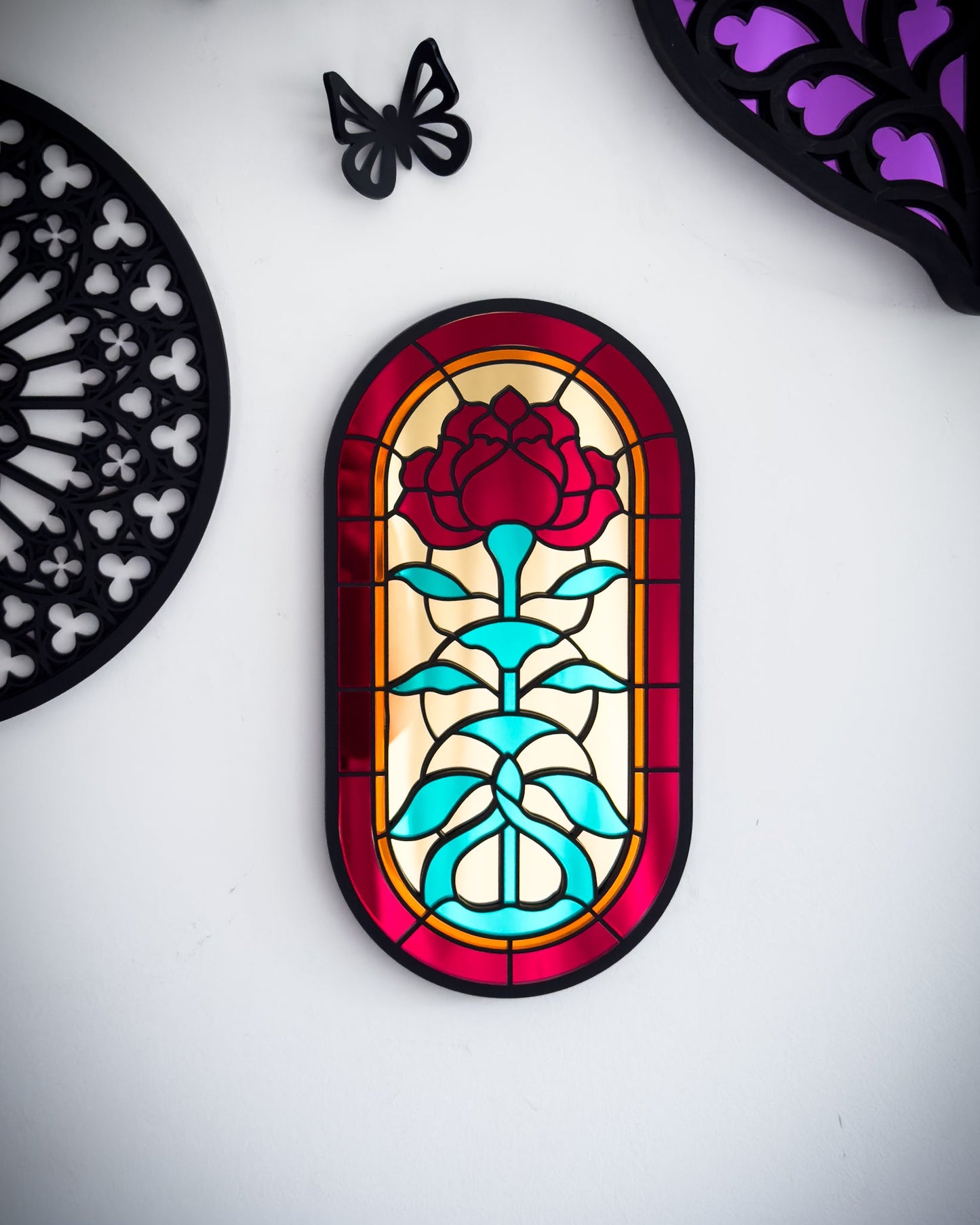 Close-up gallery wall shot of gothic stained glass style rose window mirror 