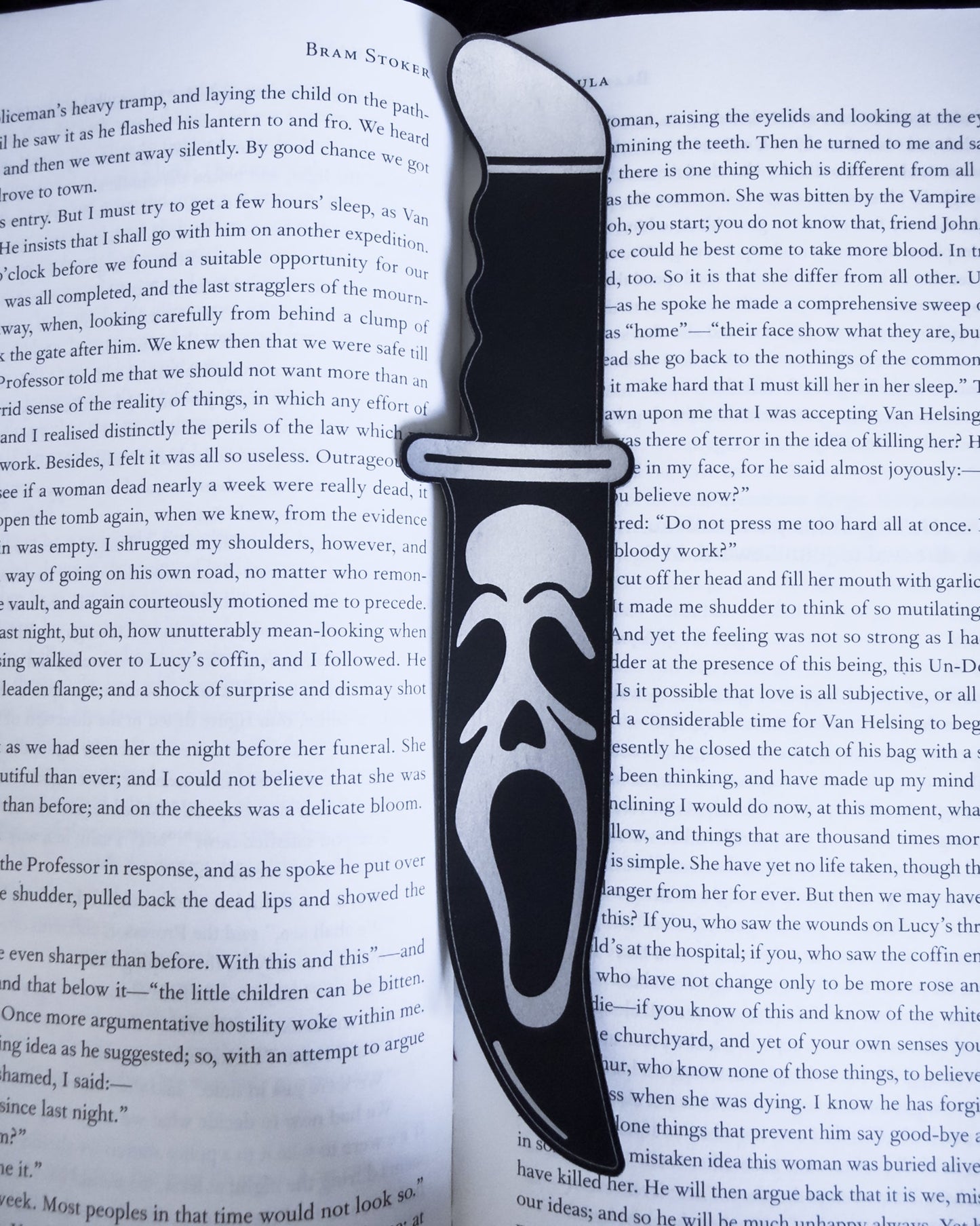 Ghostface horror bookmark in black leatherette, resting on an open book