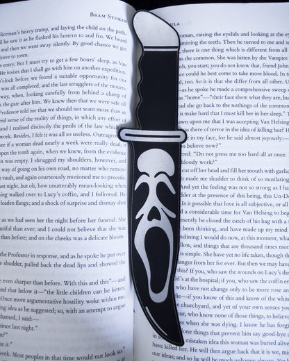 Ghostface horror bookmark in black leatherette, resting on an open book