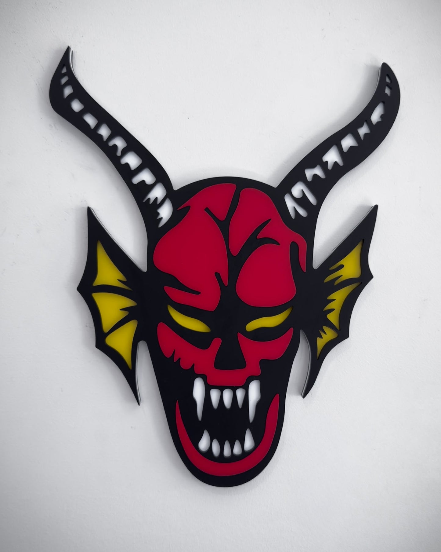 Hellfire demon acrylic wall art in red, black and yellow with horns and fangs