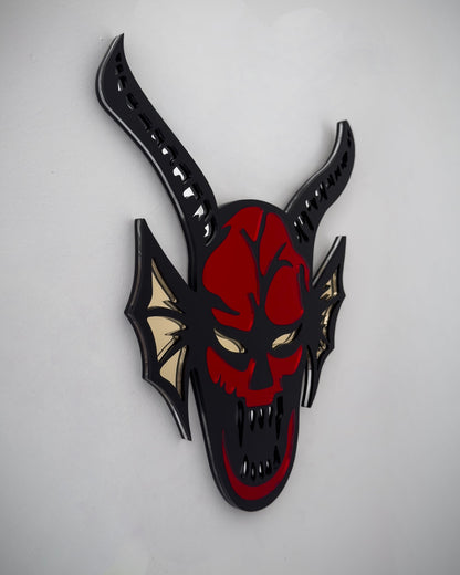 Side view of hellfire demon acrylic mirror wall art in red, black and yellow with horns and fangs