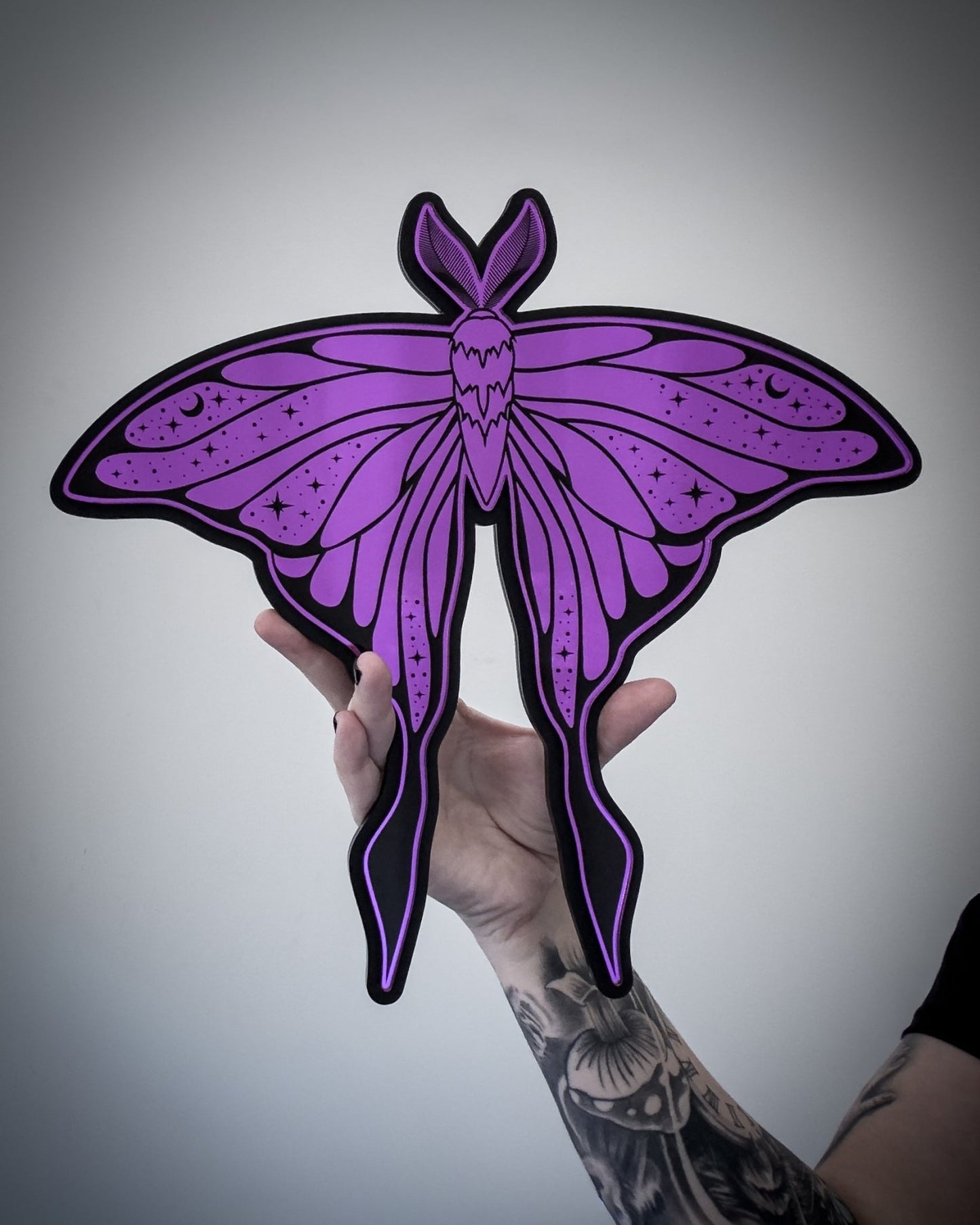 Purple luna moth wall art being held for scale gothic decor