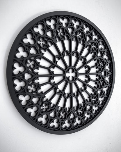Side view of Notre Dame cathedral rose window tracery wall art in black layered acrylic on a white wall