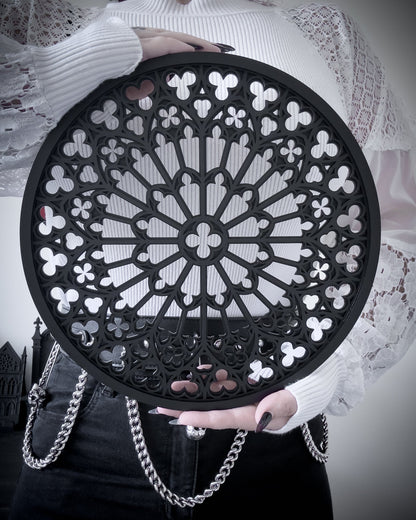 Notre Dame rose window tracery wall art in black layered acrylic, held for size reference
