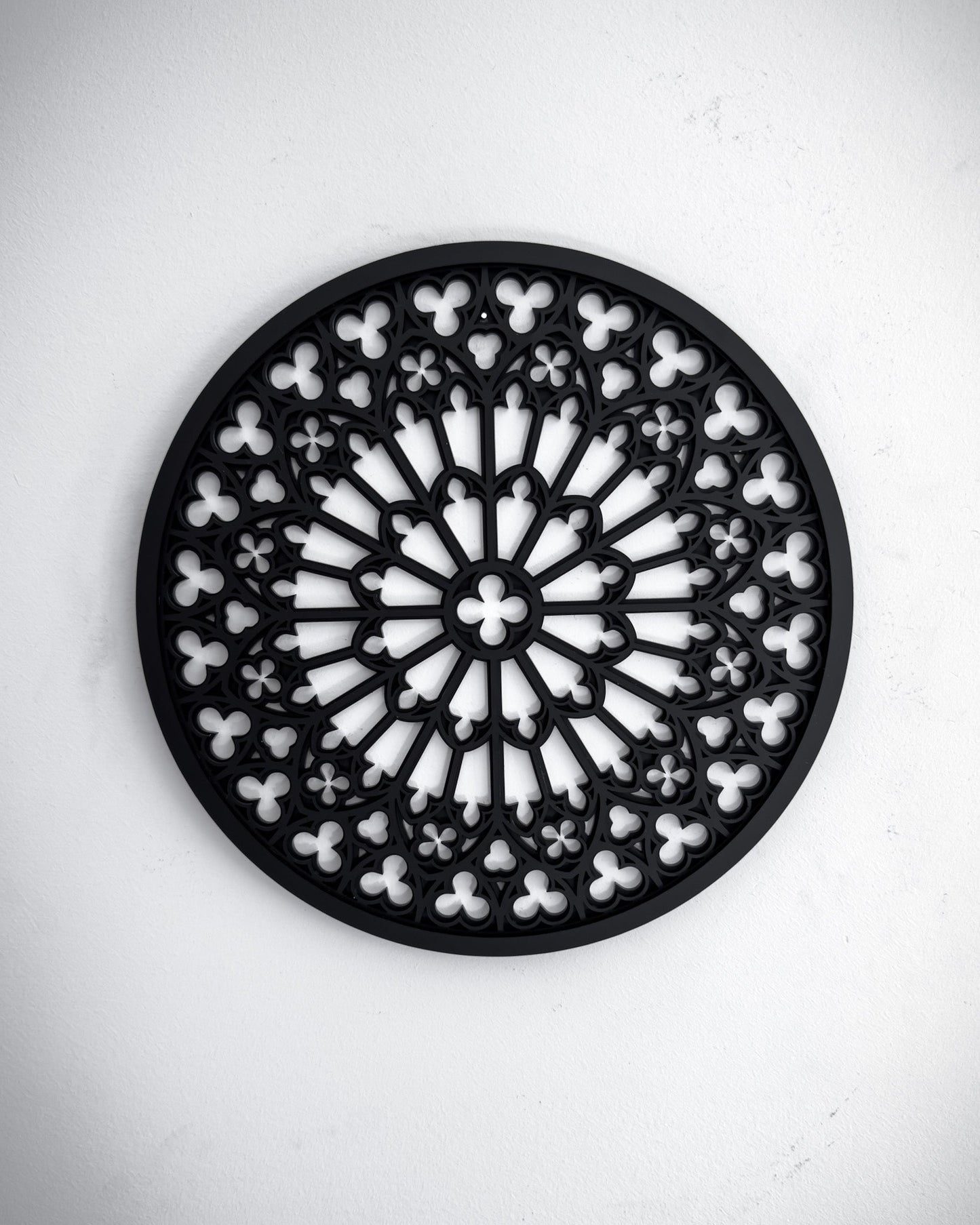 Notre Dame cathedral rose window tracery wall art in black layered acrylic on a white wall