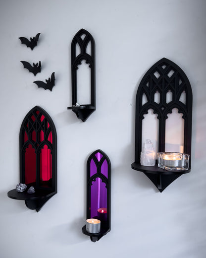 Gallery wall featuring Salem gothic tracery wall shelves with acrylic bats on a white wall with candle and trinket display