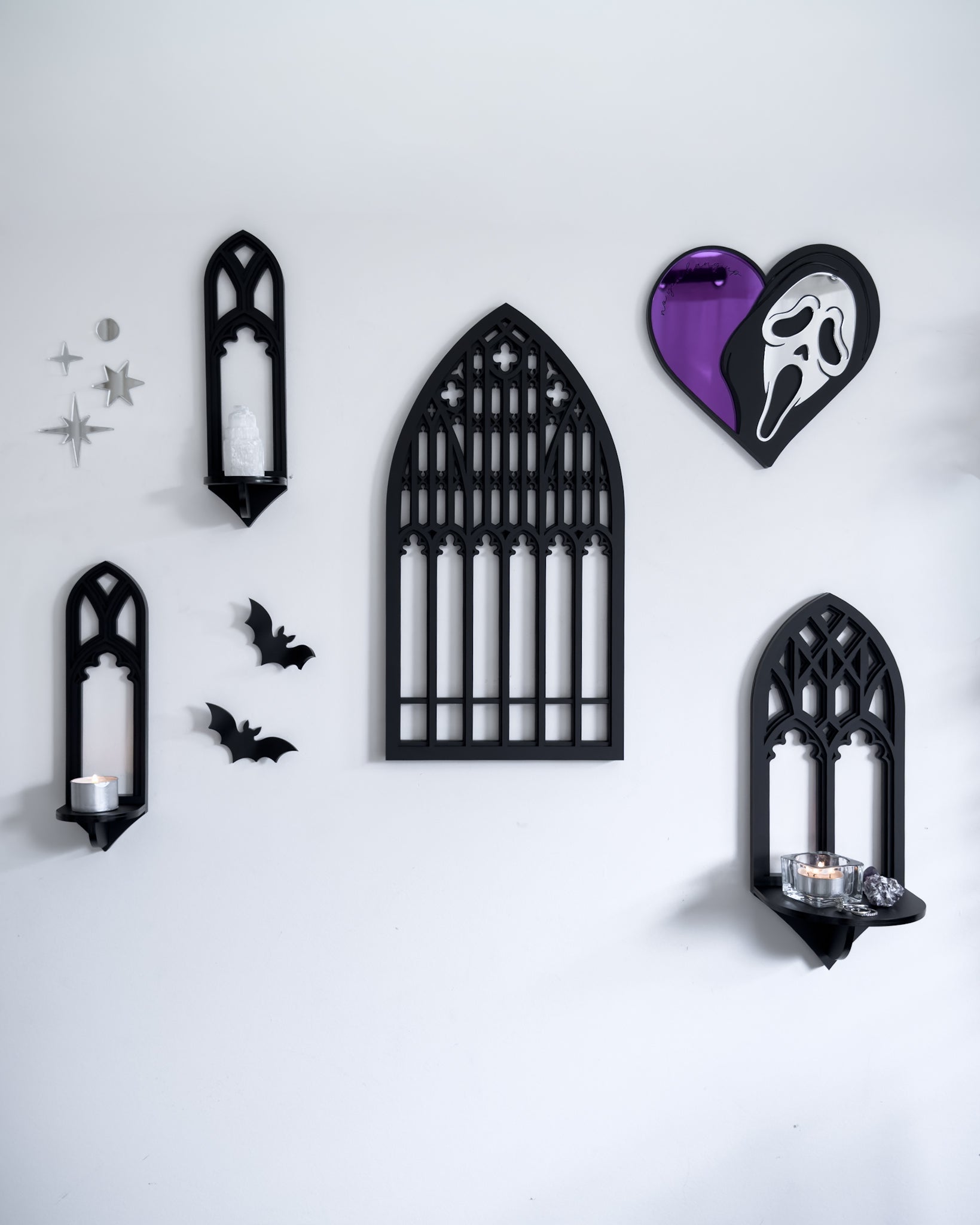 Gallery wall featuring Salem gothic tracery mirrors and wall shelves with Ghostface heart mirror and acrylic bats