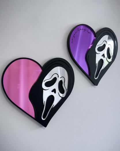 Ghostface heart mirrors in pink and purple acrylic mounted on a white wall