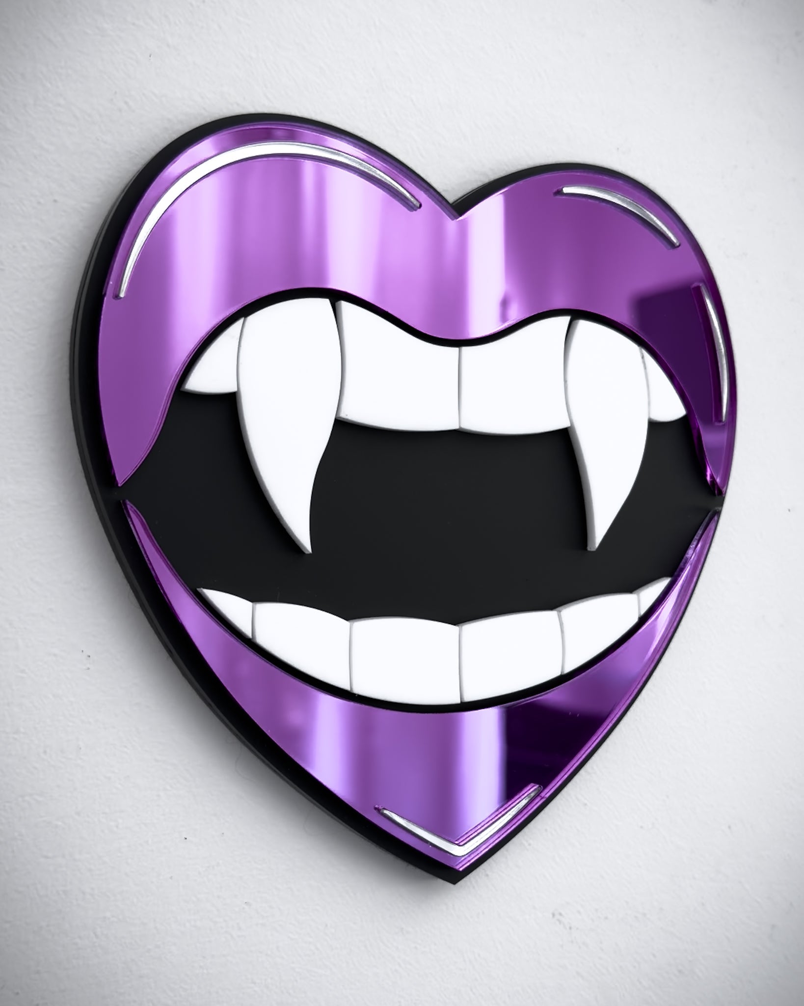 Side view of Gothic vampire lips mirror wall art in purple acrylic with fangs and black centre