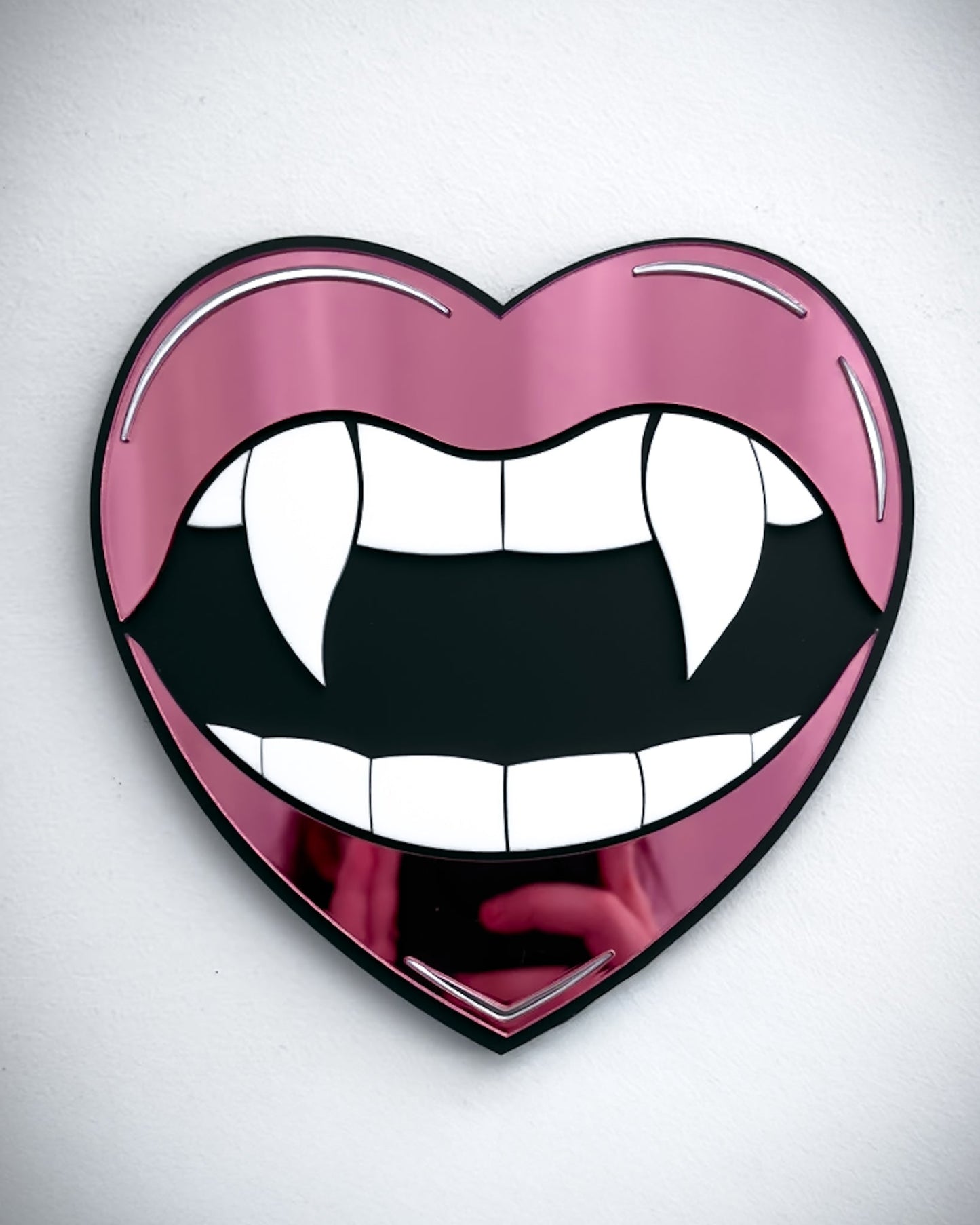 Gothic vampire lips mirror wall art in pink acrylic with fangs and black centre